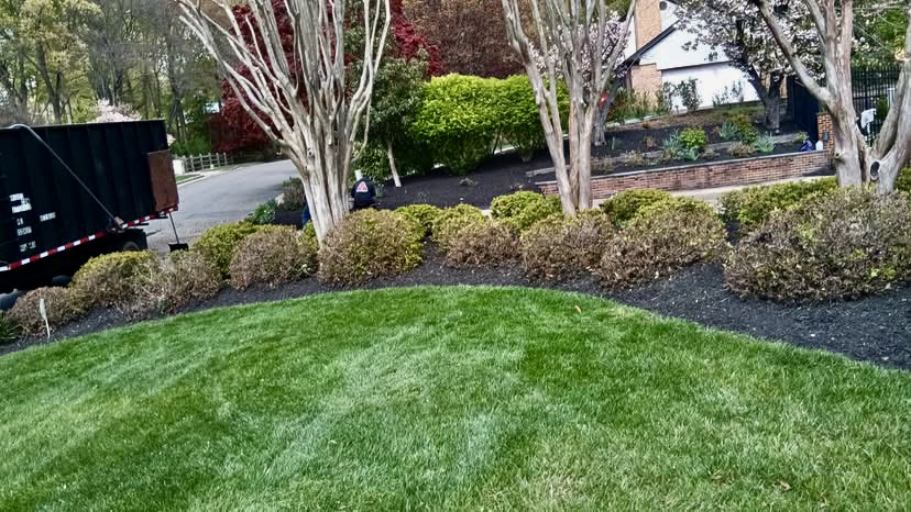 Green lawn bordered by planted landscape beds