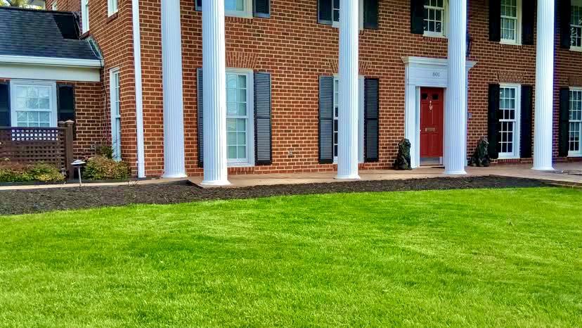 Green lawn outside a brick home