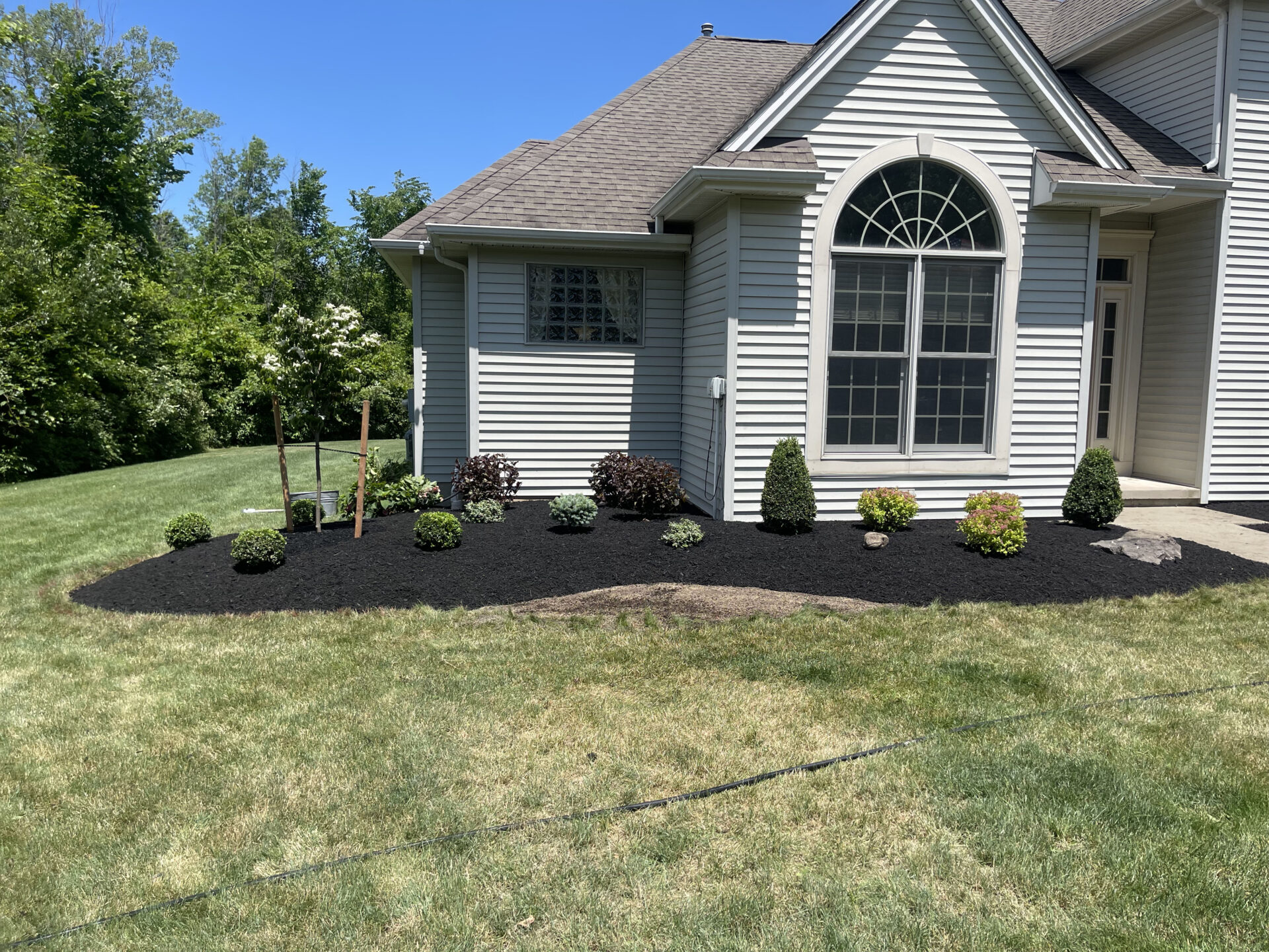 Landscaping and freshly mulched garden bed at a home